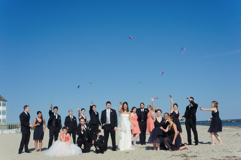 wedding party throwing glasses on beach