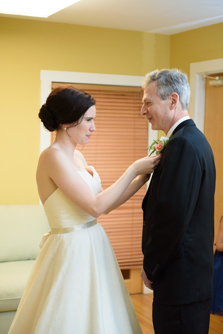 Bride Pinning Boutonniere On Dad