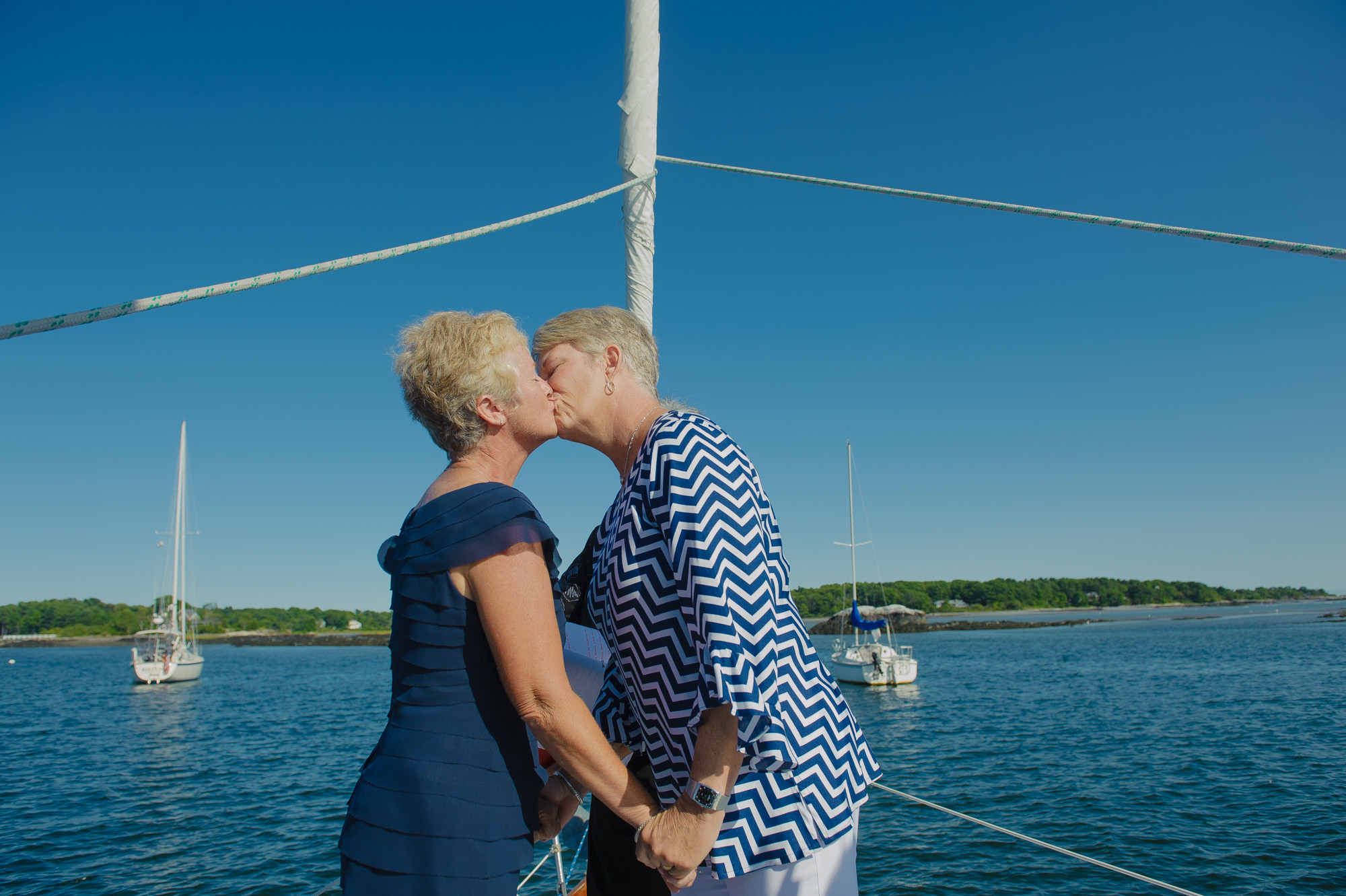 Lesbian Wedding Ceremony Kiss On Sail Boat